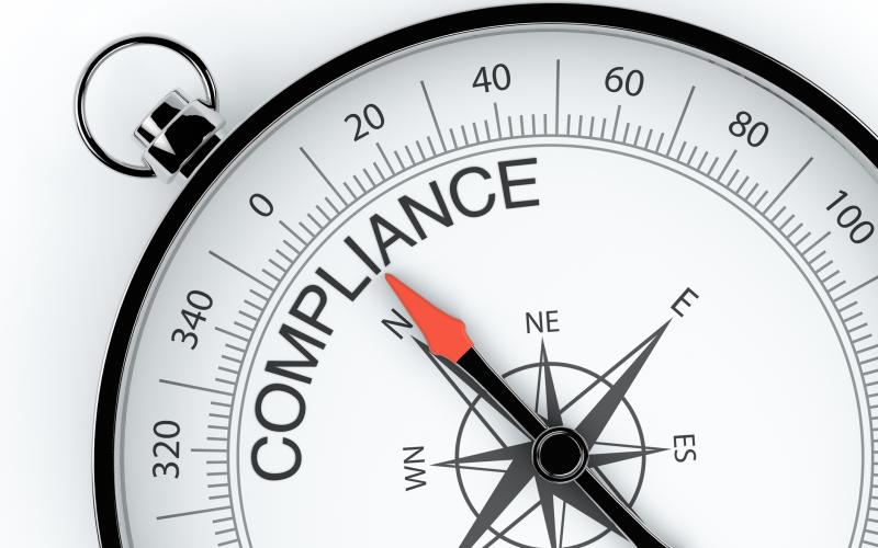 A compass pointing toward the word "COMPLIANCE."